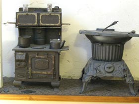 Here is a child’s cook stove, it is marked The Great Majestic Junior. It is an actual working toy stove. Imagine how years ago, a child could build a real wood fire in their toy and actually cook! The stove on the right is a King laundry stove, a small stove to heat water for washing clothes.